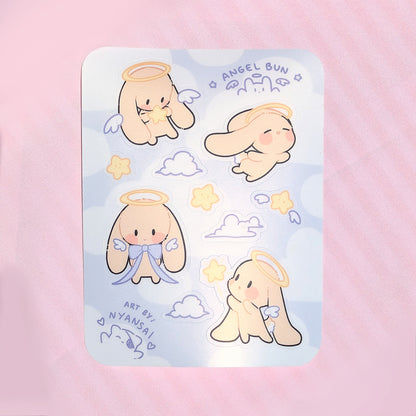 Sticker sheet with cute bunny angel-themed designs on a pink background