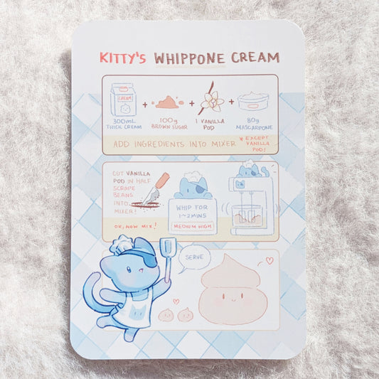 Illustrated recipe card for 'Kitty's Whippone Cream', photographed on a fluffy white background.