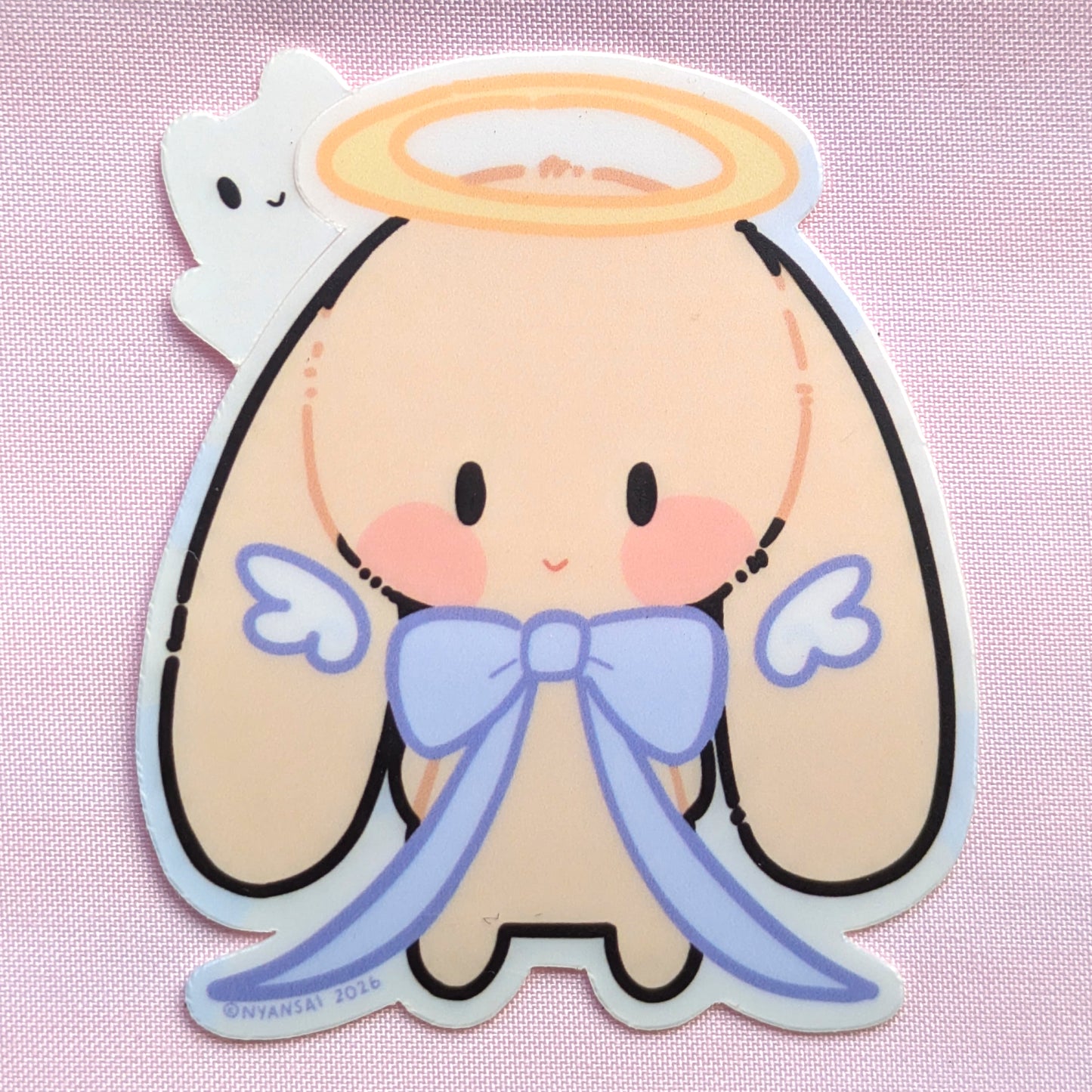 Cartoon angel character with a halo and blue bow on a pink background